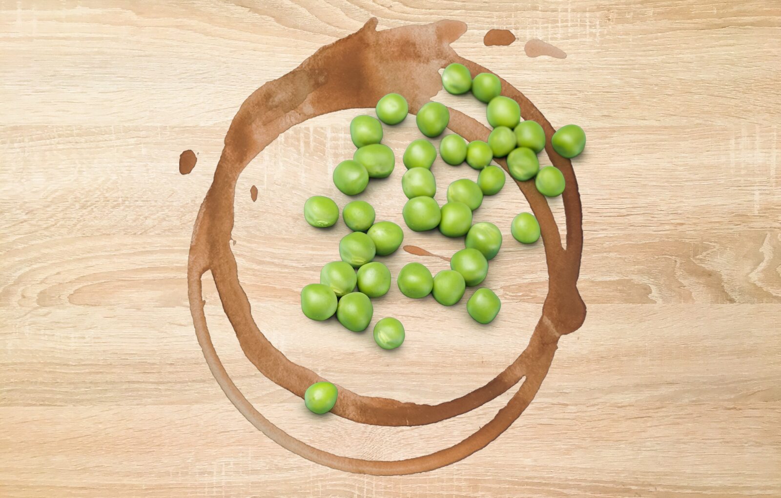 Wooden table surface covered in peas and coffee stains chasing a better life