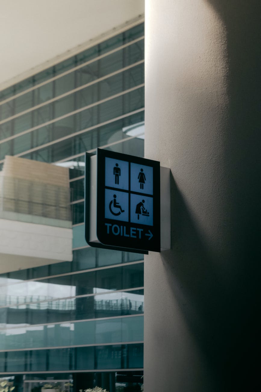 signboard of public toilet placed on wall